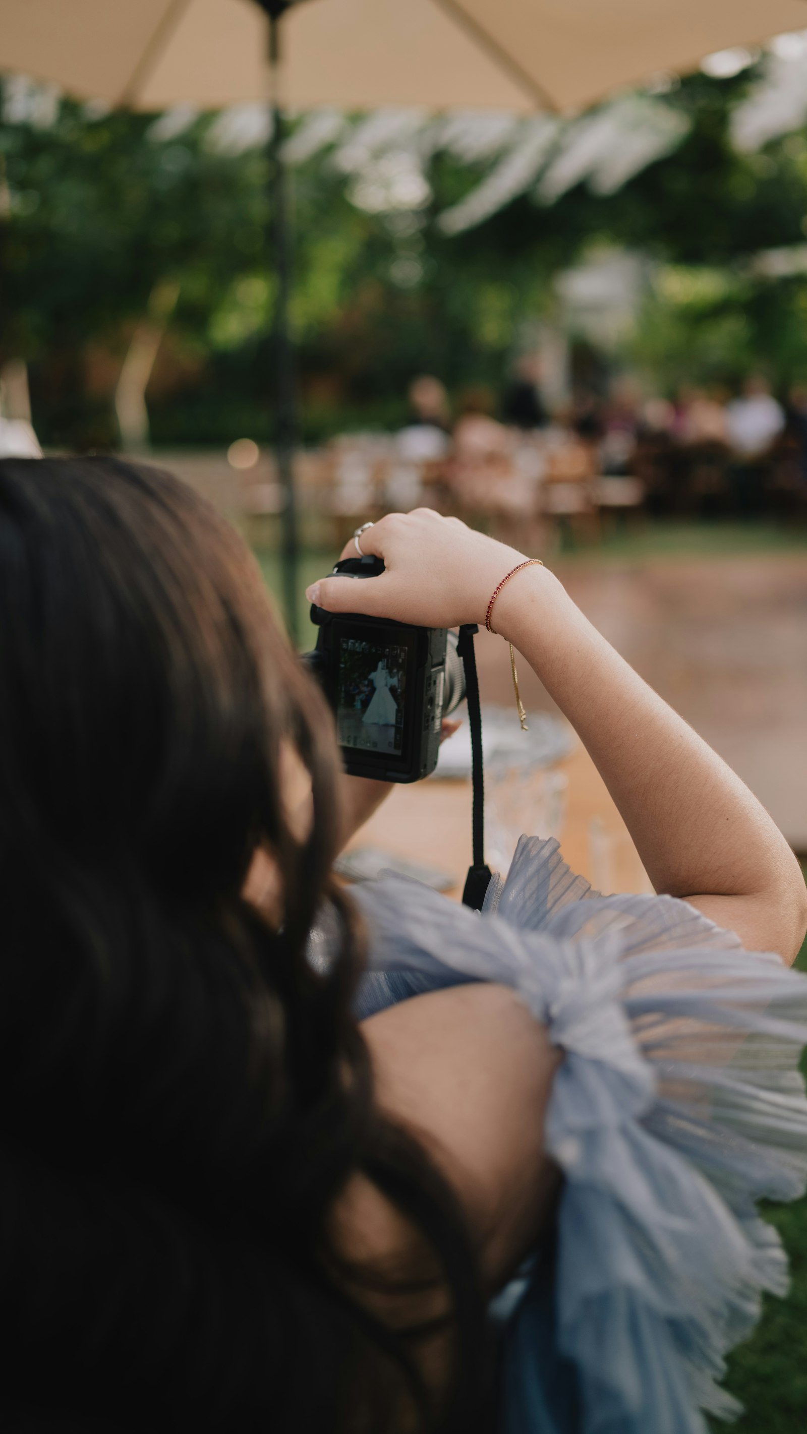 Photographer framing a shot of a bride at a wedding