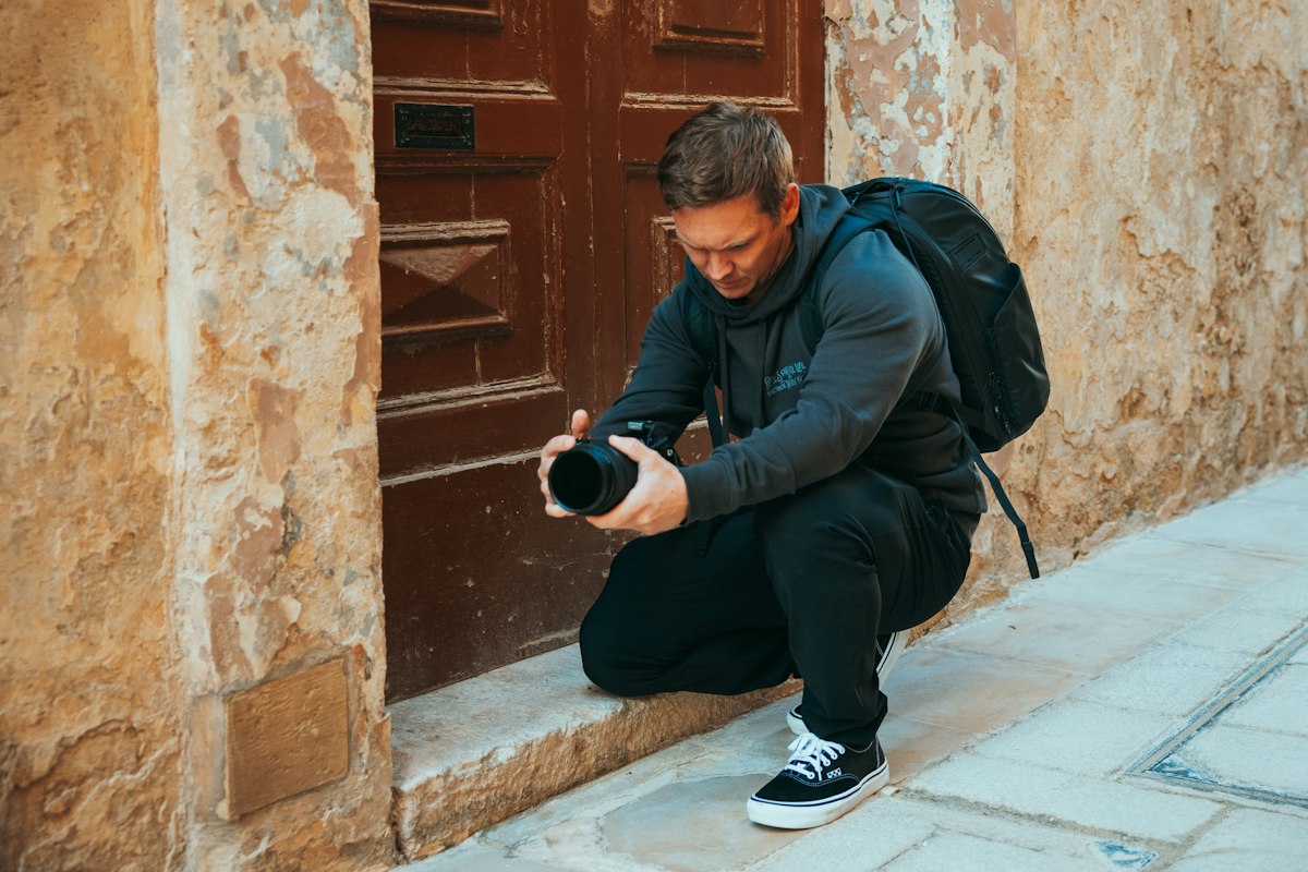 Photographer crouching to take a picture at an event